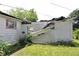 View of the damaged exterior highlighting deteriorated roofing and broken siding at 220 S 2Nd St, Summitville, IN 46070