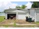 Exterior shot of the two-car garage with damaged doorway at 220 S 2Nd St, Summitville, IN 46070