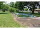 Backyard pool surrounded by a concrete deck, offering a space for outdoor relaxation and recreation at 220 S 2Nd St, Summitville, IN 46070