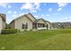 Back of the house, showing manicured lawns, covered patio with grill and nice landscaping at 2246 Heather Glen Way, Franklin, IN 46131