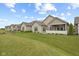 Well-manicured lawn and back of the house including a covered patio and landscaping at 2246 Heather Glen Way, Franklin, IN 46131