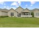 Charming home's backyard features a covered patio and green lawn, perfect for outdoor relaxation and entertaining at 2246 Heather Glen Way, Franklin, IN 46131