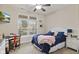 Cozy bedroom with a large window, a ceiling fan, and stylish decor, offering a comfortable retreat at 2246 Heather Glen Way, Franklin, IN 46131