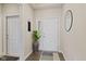 Inviting entryway features a decorative plant, a round mirror, and a stylish rug, creating a warm welcome at 2246 Heather Glen Way, Franklin, IN 46131