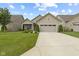 Landscaped front yard featuring a well-maintained lawn, flowering shrubs and a two-car garage at 2246 Heather Glen Way, Franklin, IN 46131