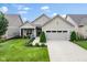 Charming home showcasing a manicured lawn and inviting front porch with stone accents and two-car garage at 2246 Heather Glen Way, Franklin, IN 46131