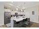 Well-lit kitchen features granite counters, stainless steel appliances, and an island with seating at 2246 Heather Glen Way, Franklin, IN 46131