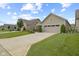 Manicured lawns lead to houses with two-car garages on a street with a sidewalk at 2246 Heather Glen Way, Franklin, IN 46131