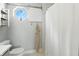 Well-lit bathroom featuring a decorative window, built-in shelving, and a shower with a white curtain at 2308 E Mill Stream Dr, Greenfield, IN 46140