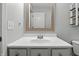 Neutral bathroom features a single vanity, framed mirror, toilet, and modern light fixture at 2308 E Mill Stream Dr, Greenfield, IN 46140