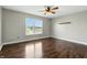 Bedroom featuring hardwood floors, a ceiling fan, and a large window providing ample natural light at 2308 E Mill Stream Dr, Greenfield, IN 46140