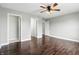 Bedroom featuring hardwood floors and multiple doorways leading to en-suite and closet at 2308 E Mill Stream Dr, Greenfield, IN 46140