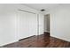 Neutral bedroom featuring hardwood floors, a closet with double doors, and an open doorway at 2308 E Mill Stream Dr, Greenfield, IN 46140