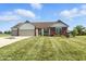 Charming single-story home featuring a manicured lawn, well-kept landscaping, and a two-car garage, perfect for curb appeal at 2308 E Mill Stream Dr, Greenfield, IN 46140