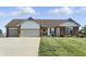 Charming single-story home featuring a manicured lawn, well-kept landscaping, and a two-car garage, perfect for curb appeal at 2308 E Mill Stream Dr, Greenfield, IN 46140
