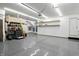 Clean garage space with epoxy floors, storage shelves, and bright overhead lighting at 2308 E Mill Stream Dr, Greenfield, IN 46140
