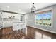 Bright kitchen with white cabinetry, modern stainless steel appliances, and a large island with seating, perfect for entertaining at 2308 E Mill Stream Dr, Greenfield, IN 46140