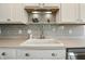 Close up on new lighting above the countertop with a gray backsplash and white cabinets at 2308 E Mill Stream Dr, Greenfield, IN 46140