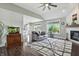 Bright living room showcasing hardwood floors, fireplace, and large windows providing ample natural light and a cozy atmosphere at 2308 E Mill Stream Dr, Greenfield, IN 46140