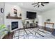 Modern living room featuring a stylish fireplace, a large flat-screen TV, and hardwood floors, perfect for relaxation and entertainment at 2308 E Mill Stream Dr, Greenfield, IN 46140
