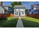 Beautifully maintained backyard with lush green grass, a concrete walkway, and string lights for ambiance at 2347 N Pennsylvania St, Indianapolis, IN 46205