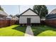 Exterior shot of backyard and detached garage with walkway and privacy fence at 2347 N Pennsylvania St, Indianapolis, IN 46205