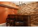 A finished basement wet bar area with a dark wood counter, stools, and a beer tap at 2347 N Pennsylvania St, Indianapolis, IN 46205