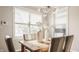 Bright dining room with modern chandelier, light wood table, and comfortable chairs, perfect for gatherings at 2347 N Pennsylvania St, Indianapolis, IN 46205