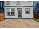 Charming home featuring a blue front door, light gray horizontal siding, and lovely exterior string lights at 2347 N Pennsylvania St, Indianapolis, IN 46205