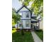 Charming two-story home features blue and grey siding, covered porch, well-kept landscaping at 2347 N Pennsylvania St, Indianapolis, IN 46205