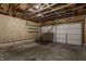 Spacious garage interior featuring concrete floors, wood walls, and shelving for ample storage options at 2347 N Pennsylvania St, Indianapolis, IN 46205