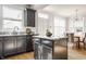 Well-lit kitchen features gray cabinets, granite countertops, stainless steel appliances, and view to dining area at 2347 N Pennsylvania St, Indianapolis, IN 46205