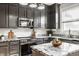Well-equipped kitchen features granite countertops, dark cabinetry, stainless steel appliances, and modern fixtures at 2347 N Pennsylvania St, Indianapolis, IN 46205
