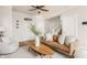 Warm and inviting living room featuring a brown leather sofa and a comfortable armchair with modern decor at 2347 N Pennsylvania St, Indianapolis, IN 46205