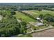 Aerial view of property featuring a tranquil pond surrounded by lush greenery and wooded area at 2868 S 525 W, Trafalgar, IN 46181