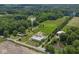 Aerial view of property with pond, wooded area, home, and large storage building at 2868 S 525 W, Trafalgar, IN 46181