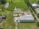 Aerial view of the property with green pasture, outbuildings, and ponds at 2868 S 525 W, Trafalgar, IN 46181