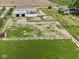 Aerial view showcasing the property's storage building, house, and potential recreational spaces at 2868 S 525 W, Trafalgar, IN 46181