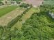 Aerial view of wooded land and property featuring a tranquil pond surrounded by lush greenery at 2868 S 525 W, Trafalgar, IN 46181