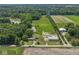 Wide aerial view of the property with a pond, pasture, trees, outbuildings, and long driveway at 2868 S 525 W, Trafalgar, IN 46181