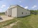Exterior of a large barn with sliding doors, set on a well-maintained grassy area, ideal for storage at 2868 S 525 W, Trafalgar, IN 46181