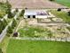 Aerial view of a barn, surrounded by a pasture area and an adjacent road, showing accessibility at 2868 S 525 W, Trafalgar, IN 46181