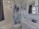 Bright bathroom featuring a shower with white tiling and modern fixtures and a decorative shower curtain at 2868 S 525 W, Trafalgar, IN 46181