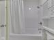 Bright bathroom with a clean white shower and tub combination, complemented by white tile and a shower curtain at 2868 S 525 W, Trafalgar, IN 46181