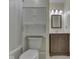 Well-lit bathroom featuring a toilet with storage space above and a vanity with a framed mirror and decorative lighting at 2868 S 525 W, Trafalgar, IN 46181