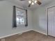 Inviting bedroom featuring hard floors, a ceiling fan, a white closet door and a window with natural light at 2868 S 525 W, Trafalgar, IN 46181