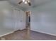 Inviting bedroom featuring hard floors, a ceiling fan, and a white closet door at 2868 S 525 W, Trafalgar, IN 46181