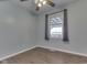 Inviting bedroom featuring hard floors, a ceiling fan, and a window with a view to the outside at 2868 S 525 W, Trafalgar, IN 46181