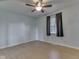 A spacious bedroom has neutral paint, a ceiling fan, and a large window at 2868 S 525 W, Trafalgar, IN 46181