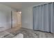 Comfortable bedroom with light blue walls, neutral curtains, carpet and an open doorway to another room at 2868 S 525 W, Trafalgar, IN 46181